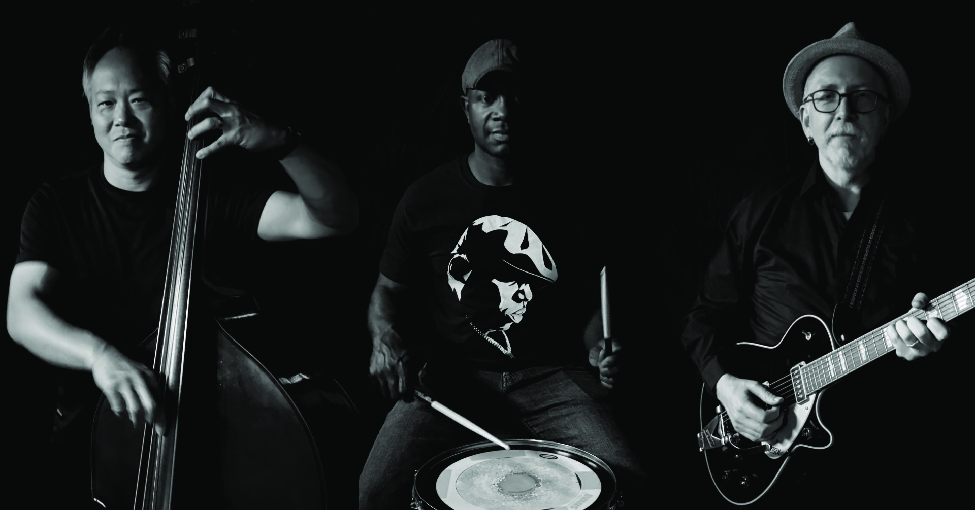 Tank! trio — upright bass, drums and guitar, photographed in low light